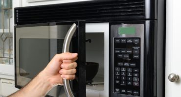 Connect the microwave under a wall cabinet or shelf